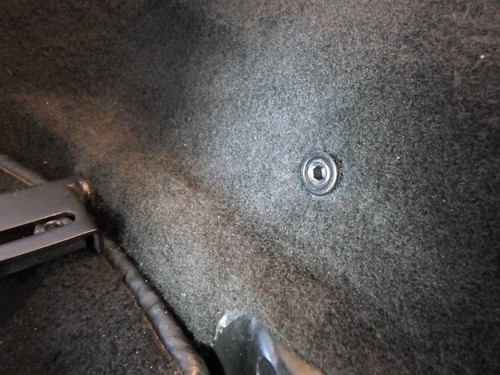 Seat belt anchor hole blanking